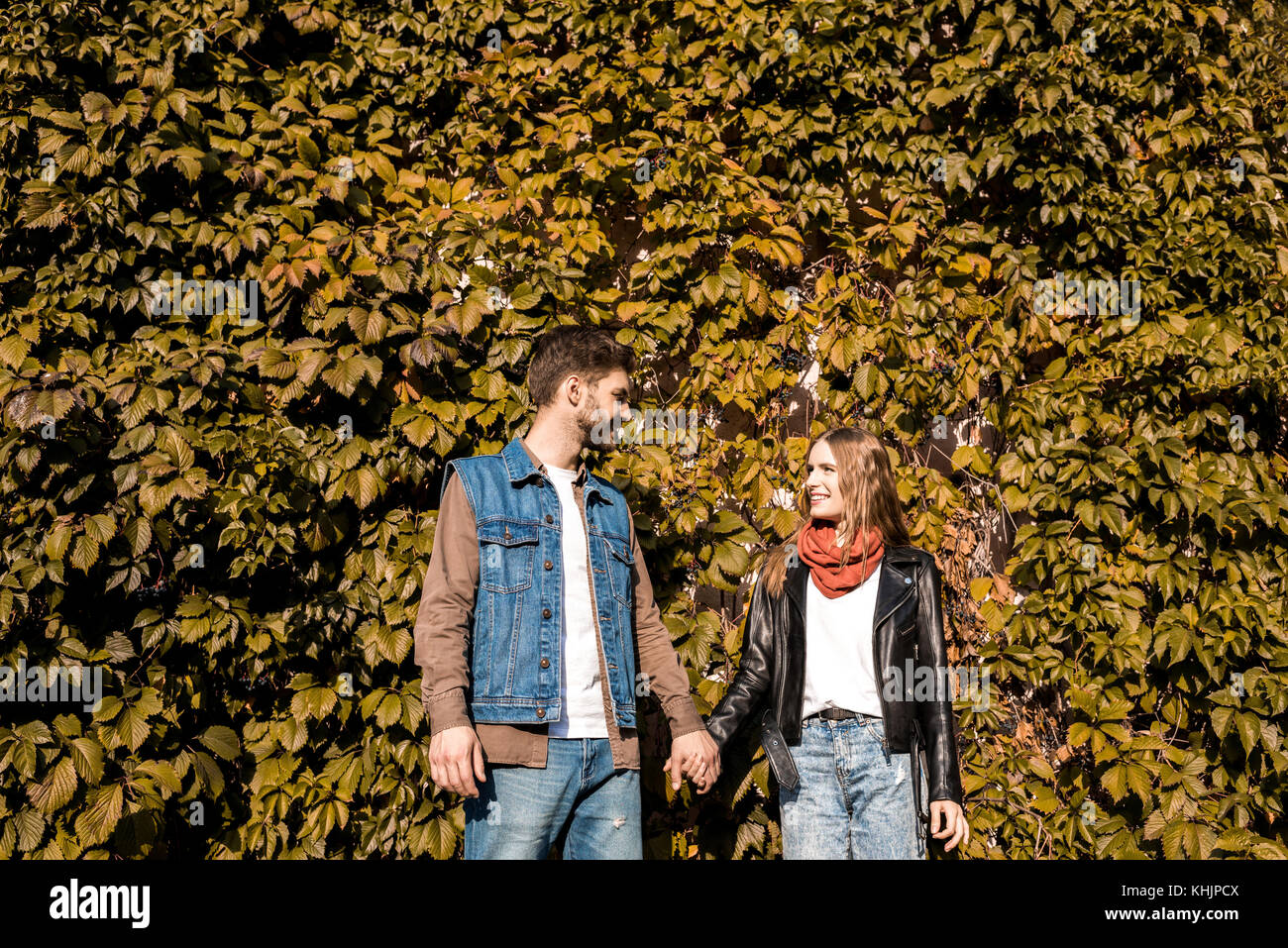 couple holding hands in autumn park Stock Photo