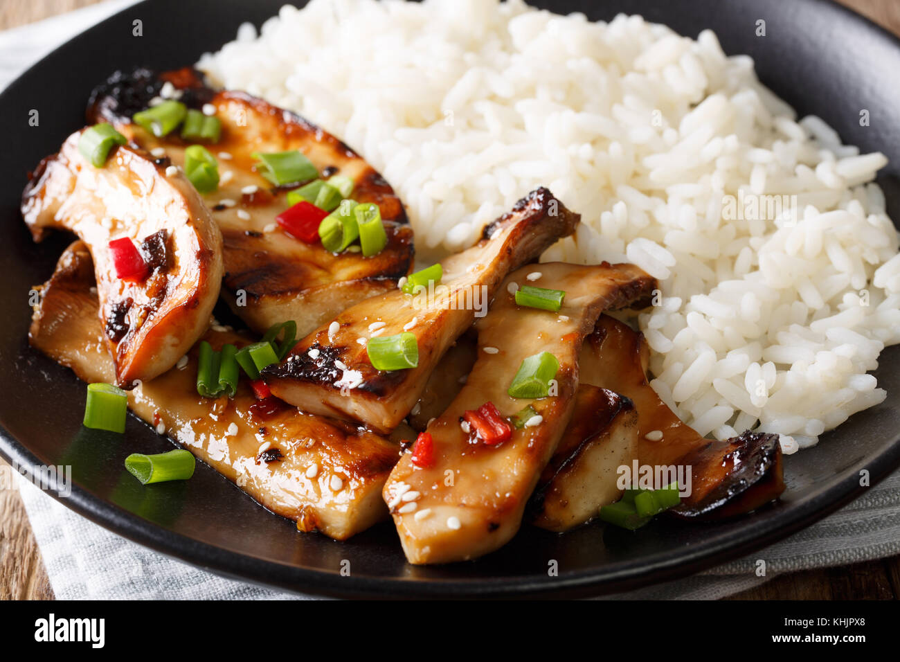 grilled king oyster mushrooms with rice and teriyaki sauce close-up on a plate. horizontal Stock Photo