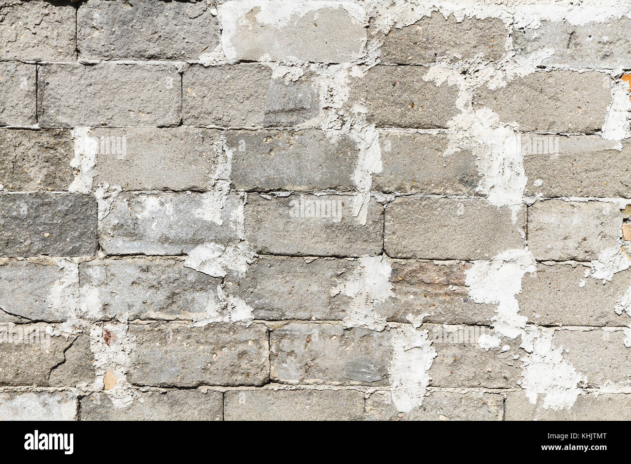 Old and weathered gray concrete block (or cinder breeze block) brick
