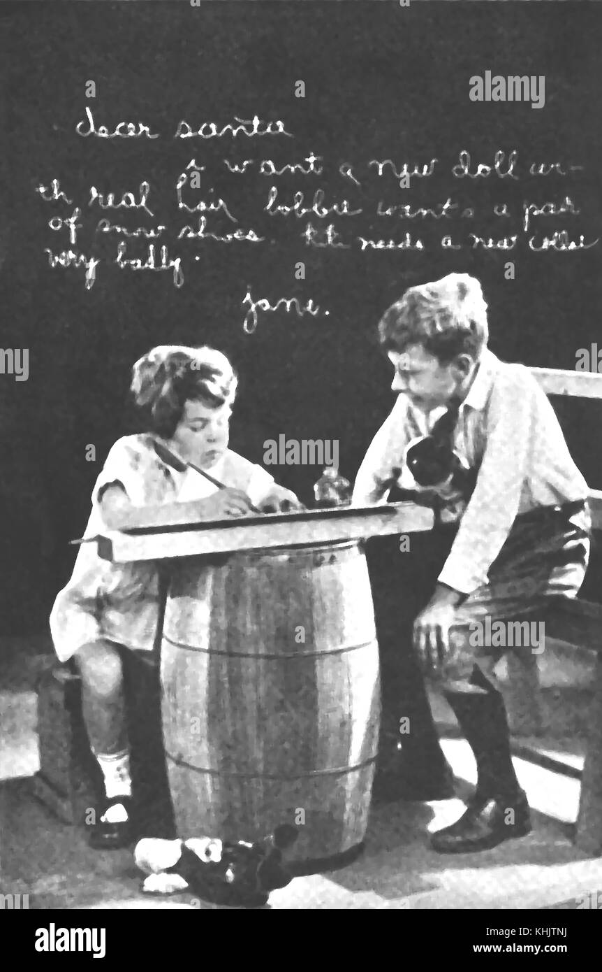 CHRISTMAS - Victorian children using a barrel as a table to write a letter to Santa Claus Stock Photo