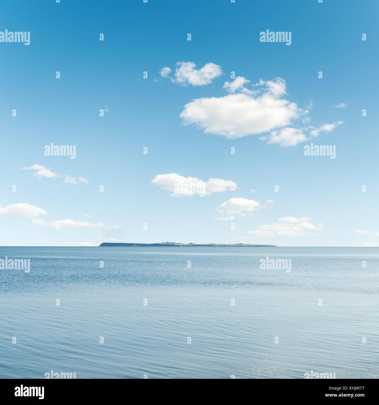 white clouds in blue sky over sea Stock Photo - Alamy