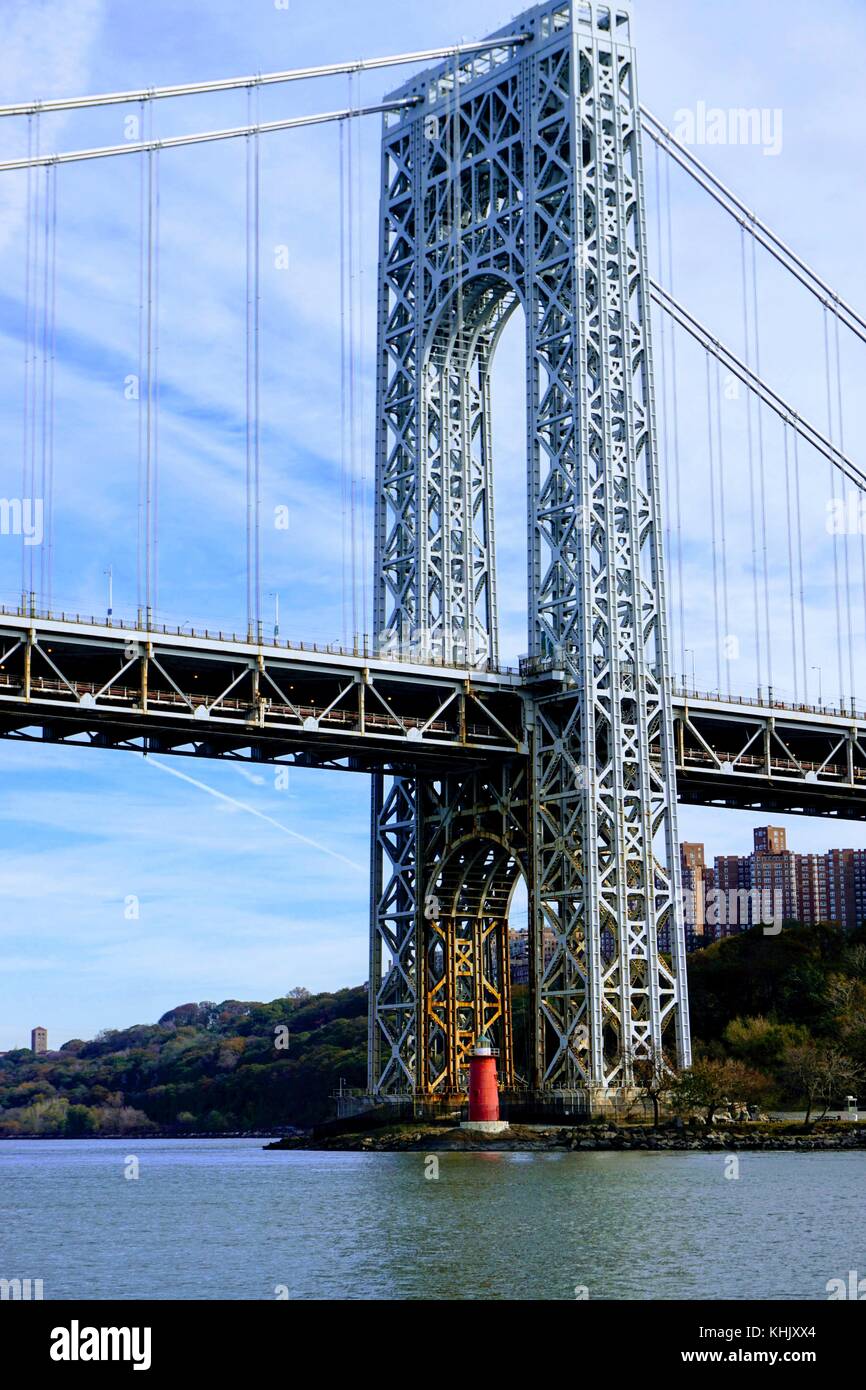 George Washington Bridge standing tall over the Little Red Lighthouse, on the Hudson River in New York, NY Stock Photo