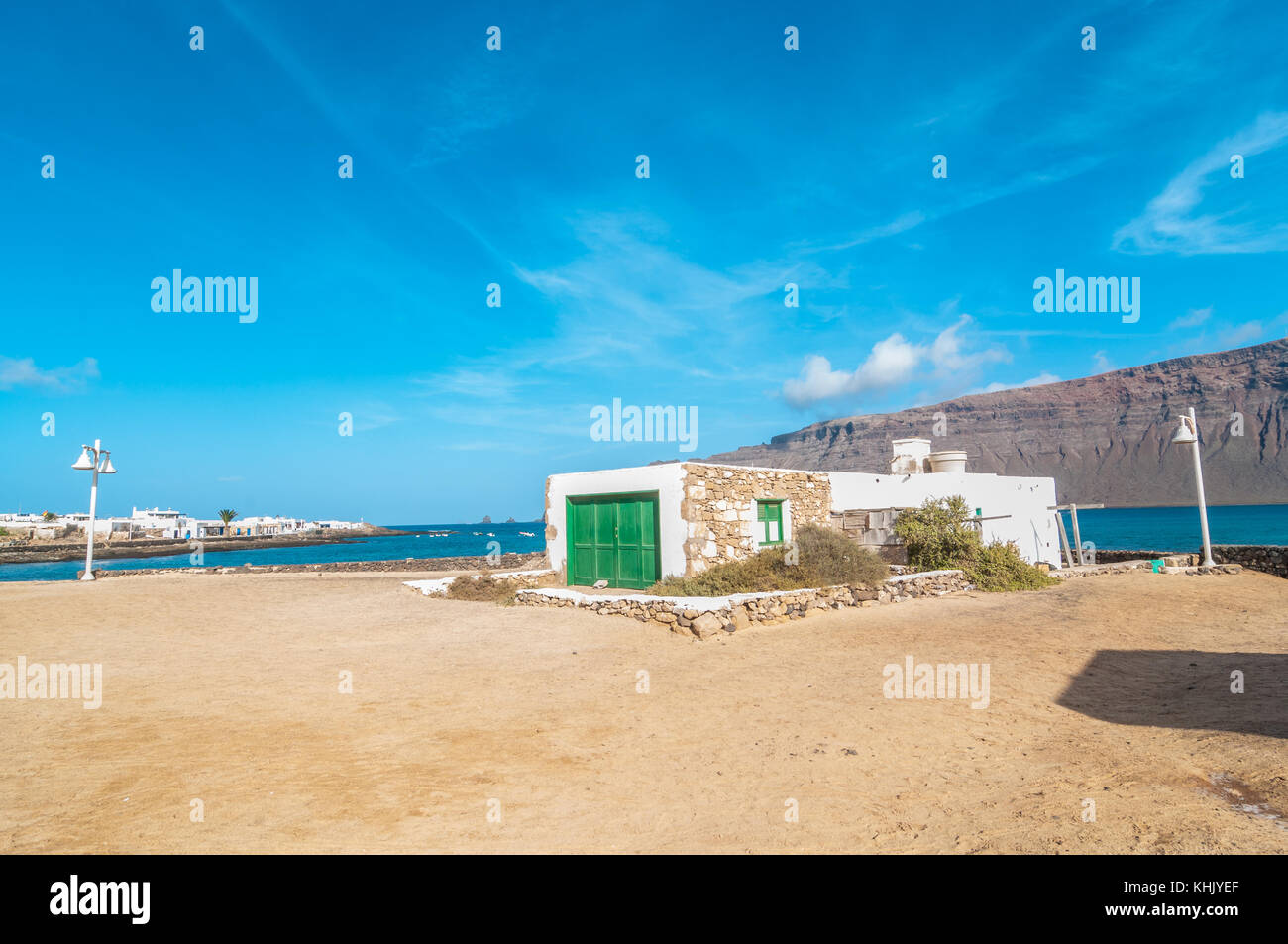 view of a typical street of Caleta del Sebo with an old house in the foreground, La Graciosa, Canary Islands, Spain Stock Photo