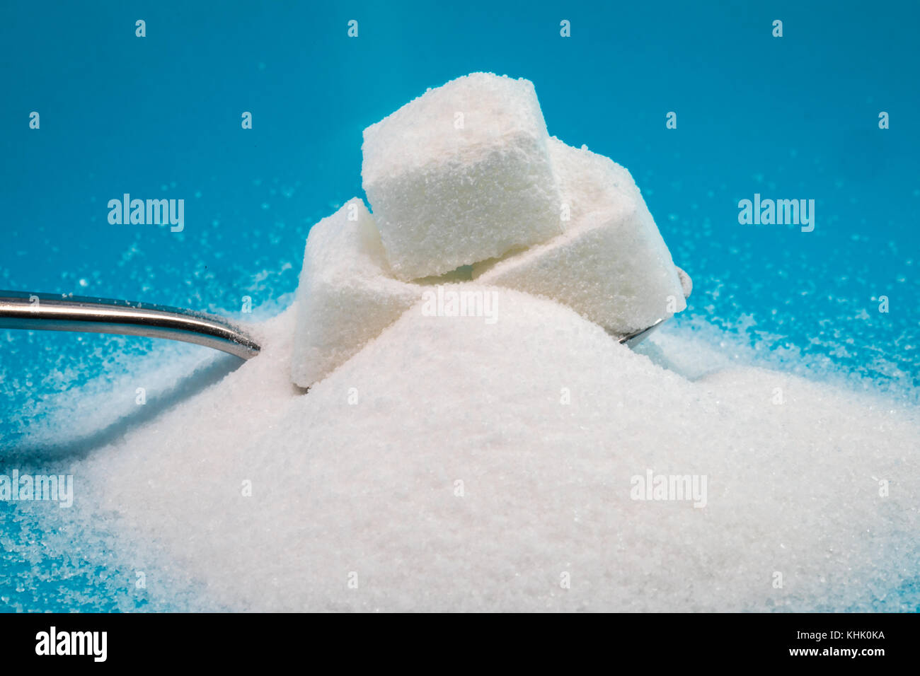 Sugar and sugar lumps on a tea spoon Stock Photo