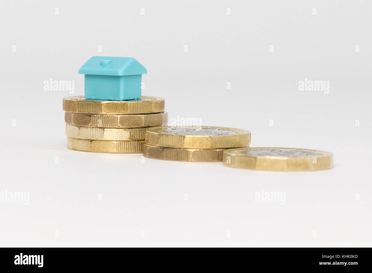 small house stacked on new uk pound coins Stock Photo