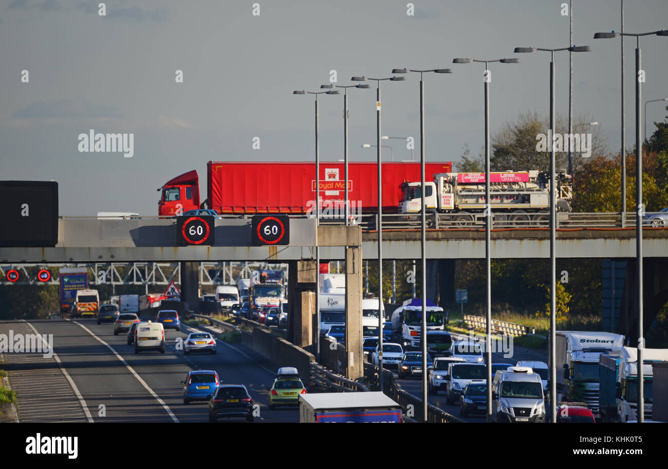 reduced speed limit warning signs in heavy traffic congestion on the m62 motorway at rush hour leeds united kingdom Stock Photo