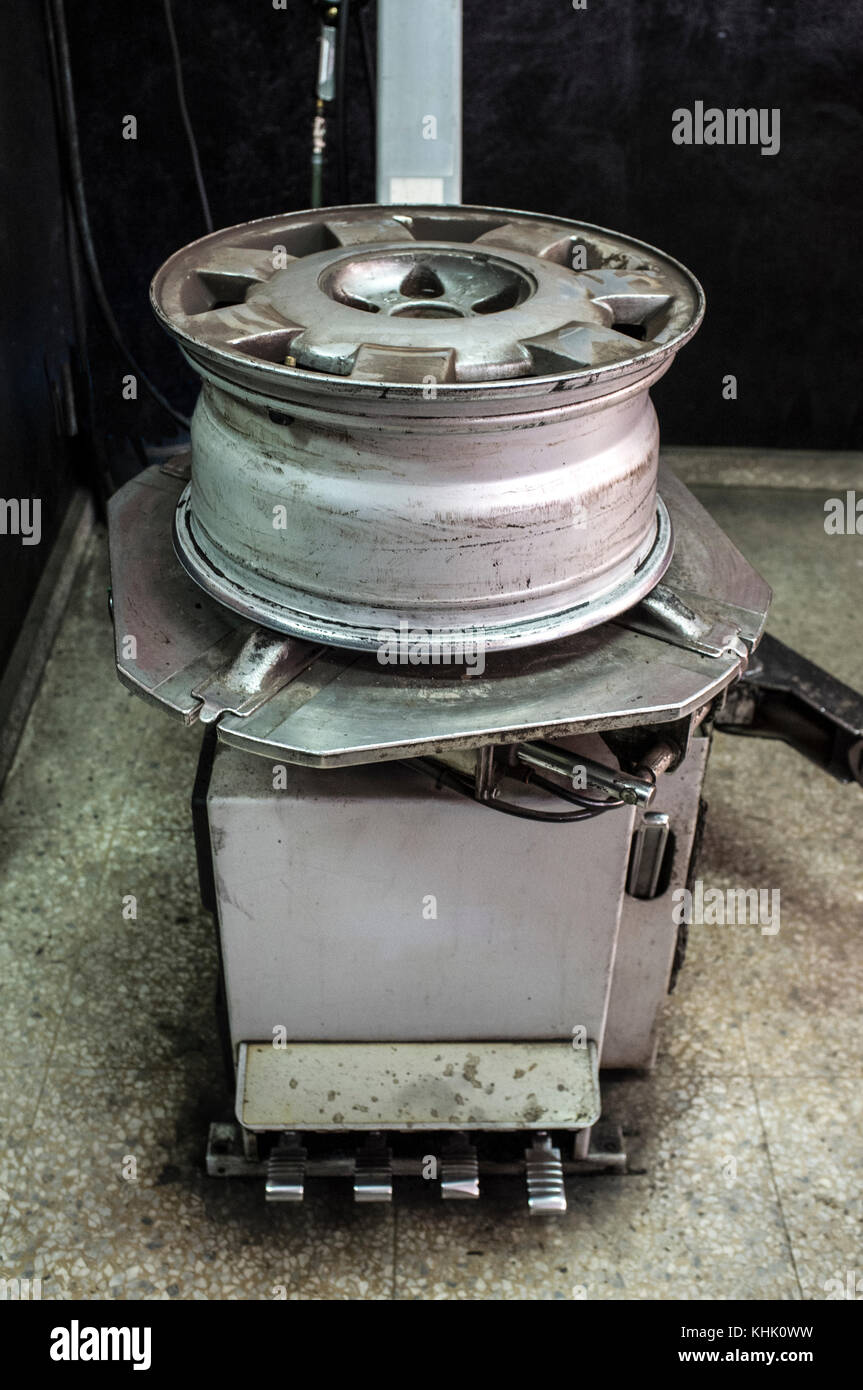 Rim with no tyre over mounting machine. Installing wheel process Stock