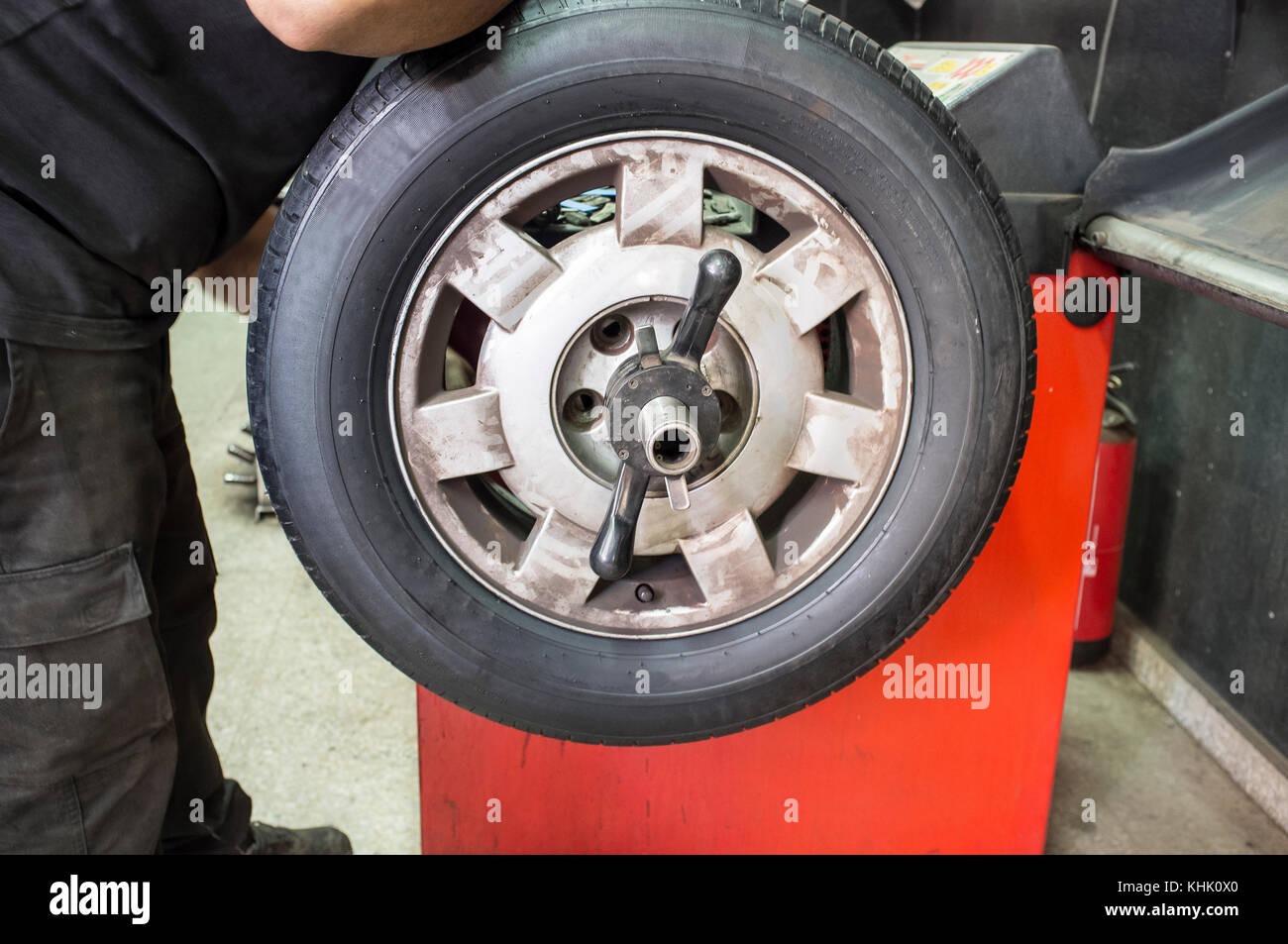 Technician work with mechanic balancing wheel. Installing wheel process Stock Photo Alamy