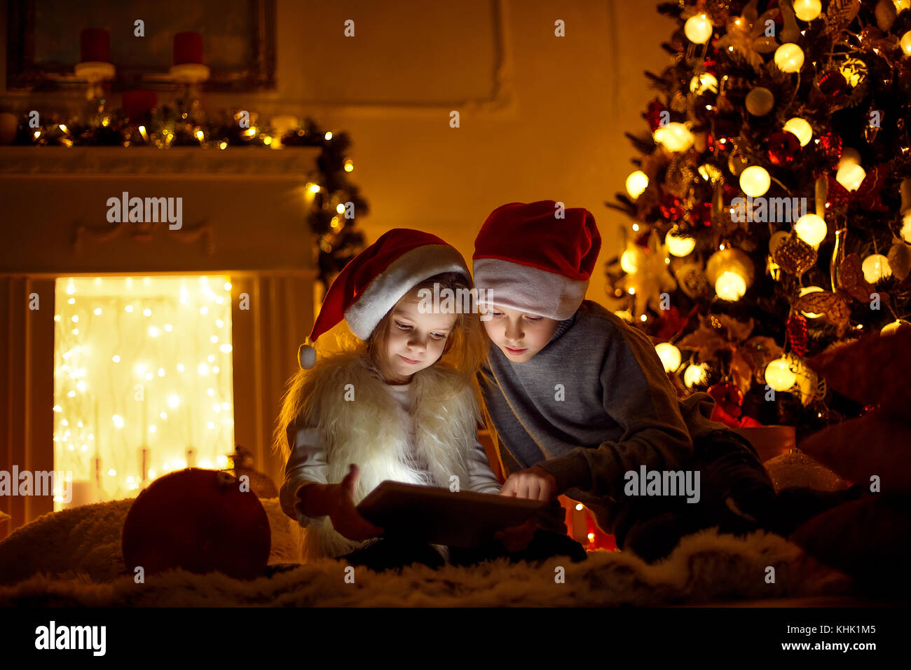 Excited children near Christmas tree Stock Photo