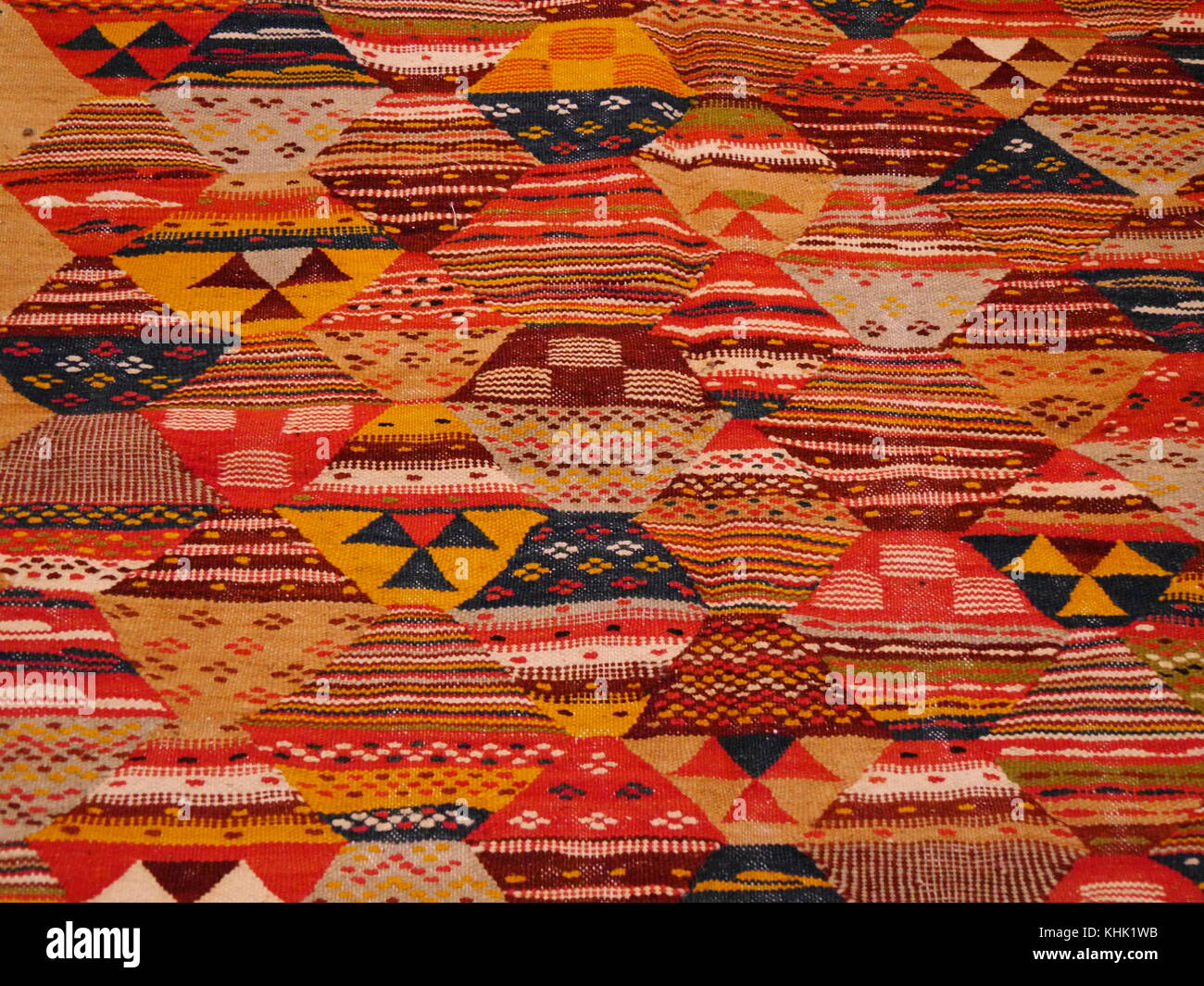 Close up of part of traditional handmade Moroccan carpet with intricate bright geometric pattern Stock Photo