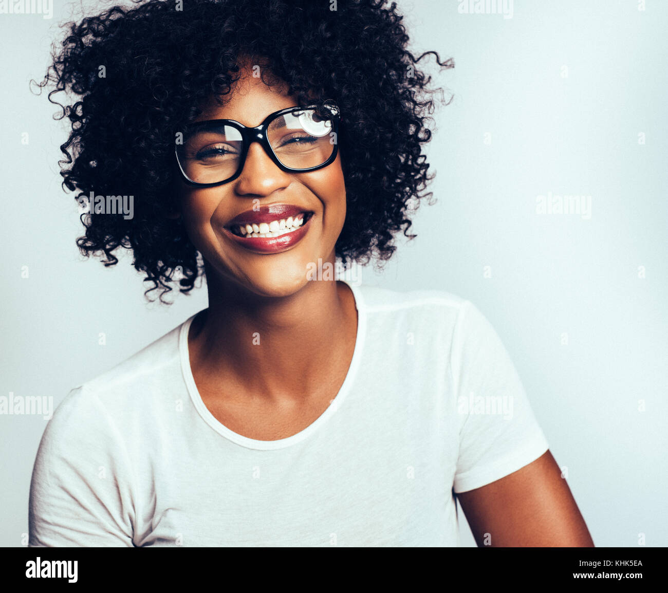Attractive young African women with curly hair and wearing glasses ...