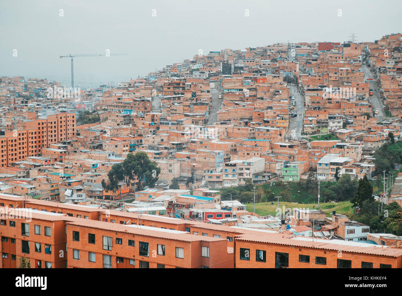 Looking out over the terracotta brick houses on the hillside suburb of Las Colinas, a neighbourhood in Bogotá, Colombia Stock Photo
