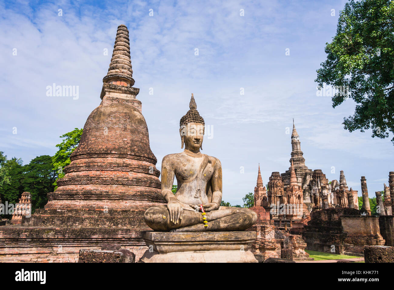 Overview of Stupa and Buddha Statue in Wat Mahathat Temple, Sukhothai Historical Park, Thailand Stock Photo