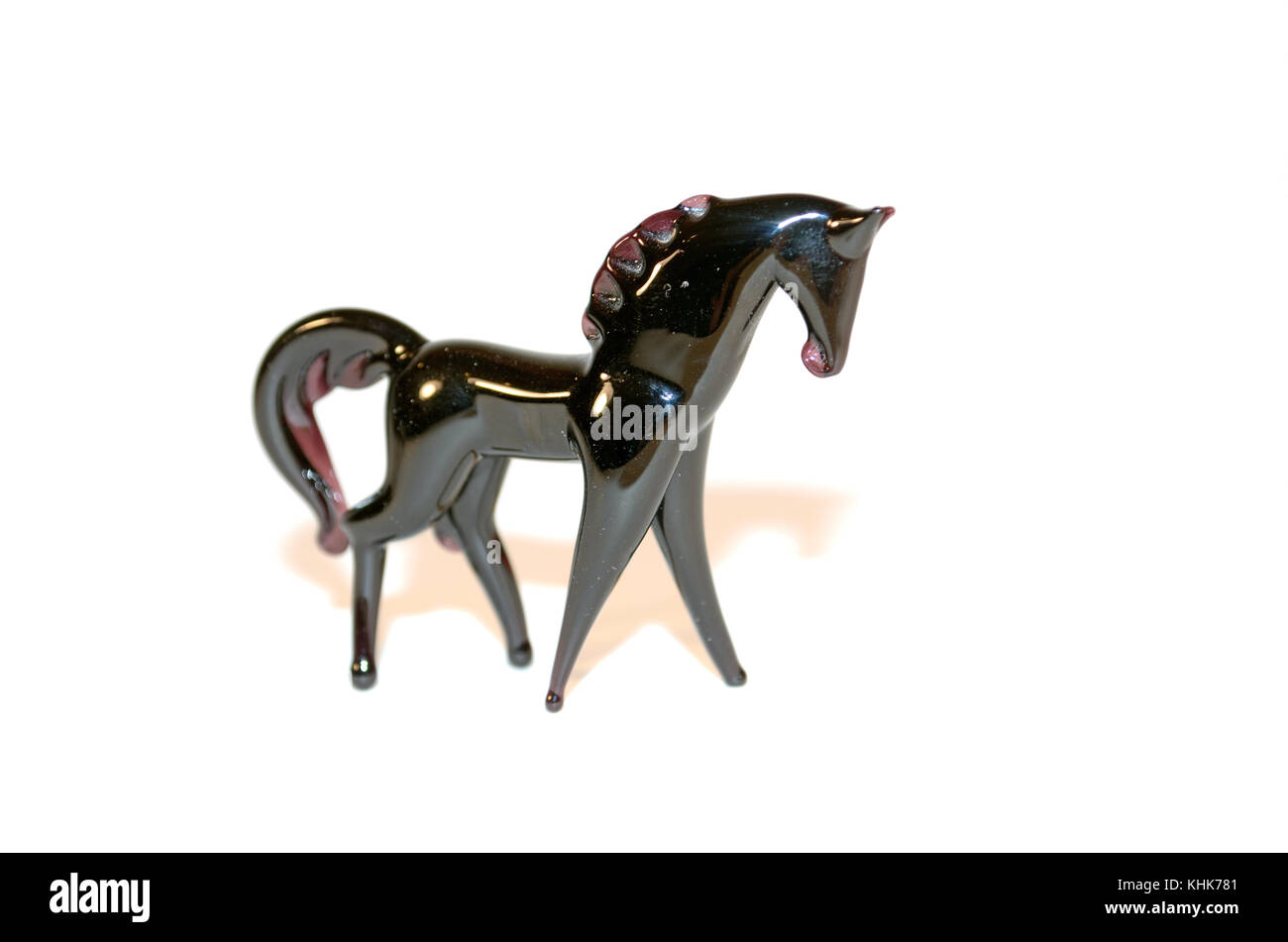 Miniature glass horse contrasted on a white background. Stock Photo