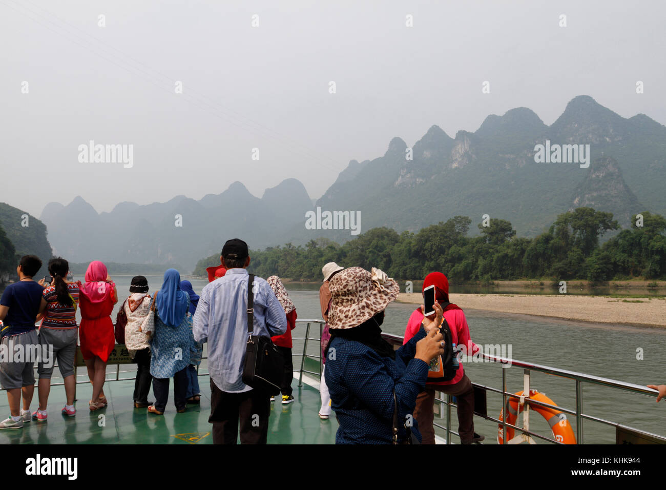 Tourists on a boat admiring the view in Guilin, China. Stock Photo