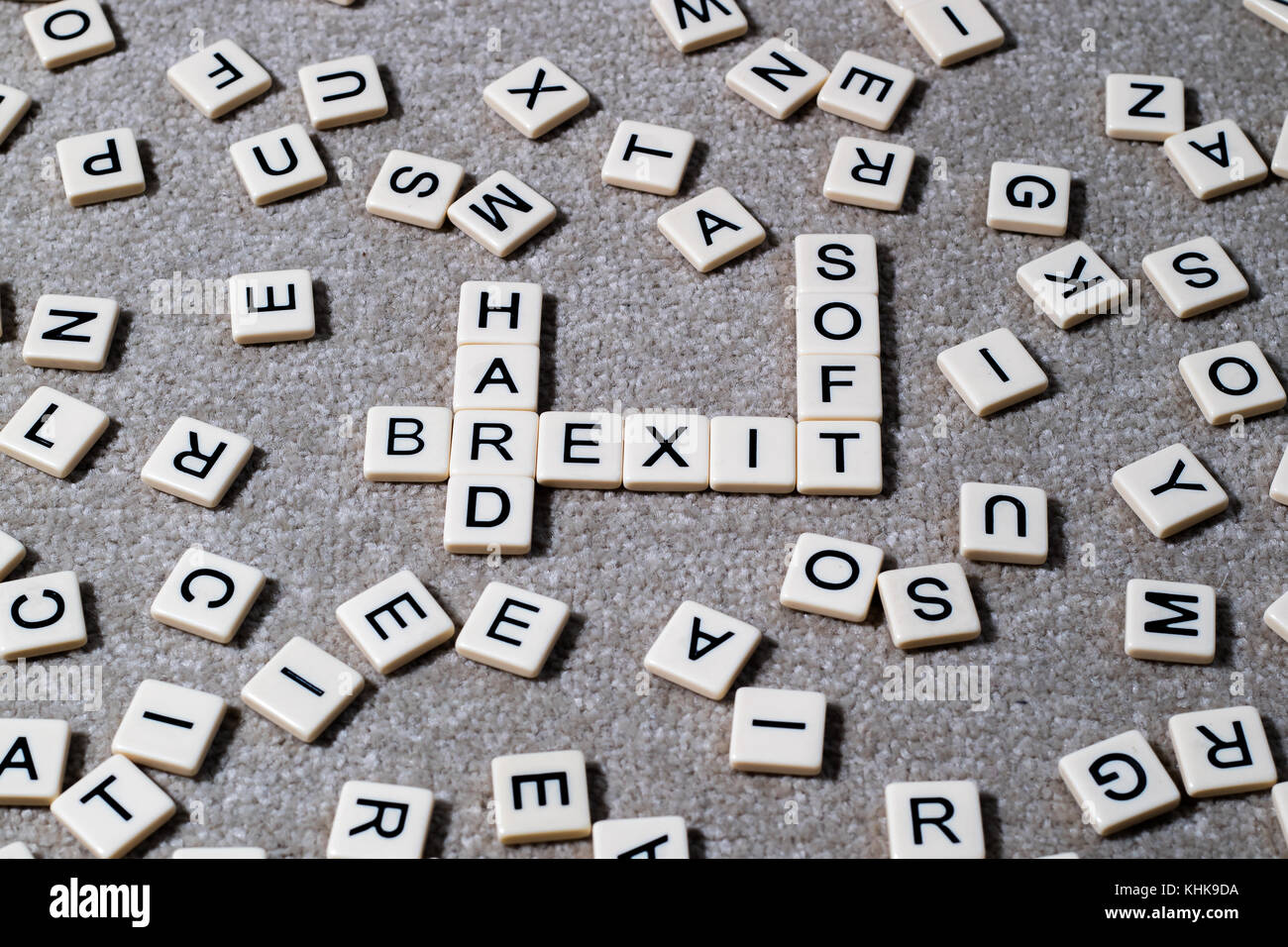 Hard Brexit & Soft Brexit spelled out on scrabble style lettered tiles amongst a jumble of other letters. Stock Photo