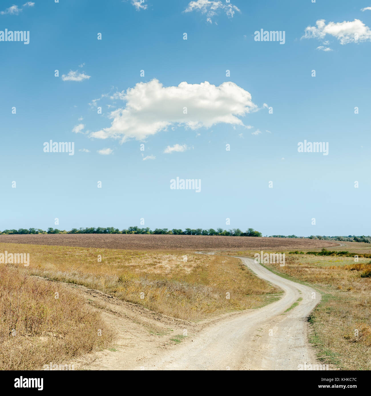 two rural roads in steppe and cloud in blue sky Stock Photo - Alamy