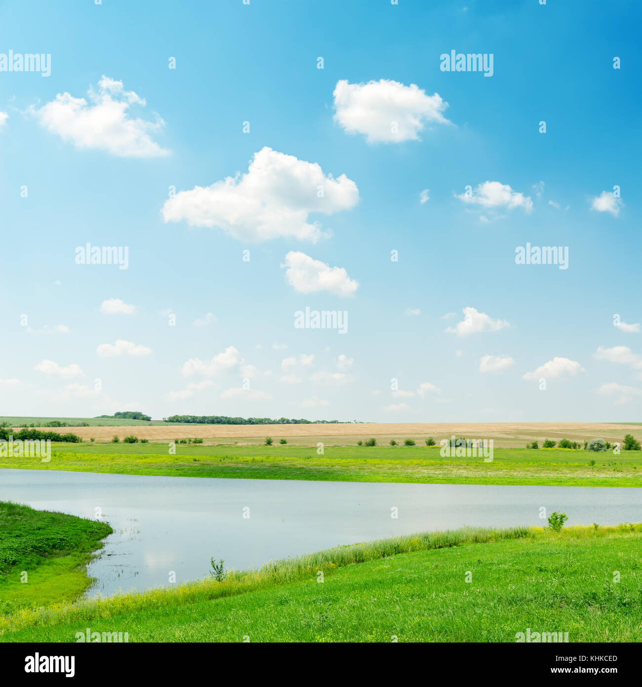 river in green grass under cloudy sky Stock Photo - Alamy