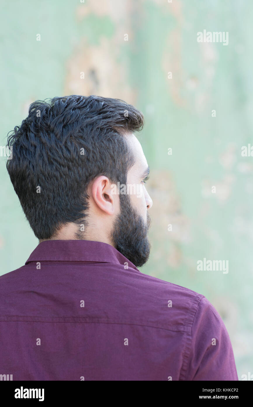 Rear view of a bearded Middle Eastern man looking away outdoors Stock Photo