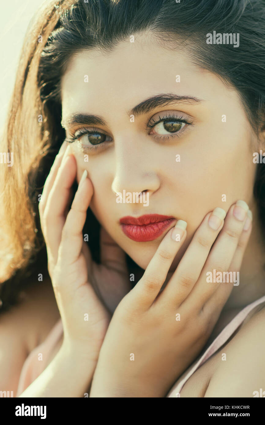 Neautiful young woman hands touching face outdoors Stock Photo - Alamy