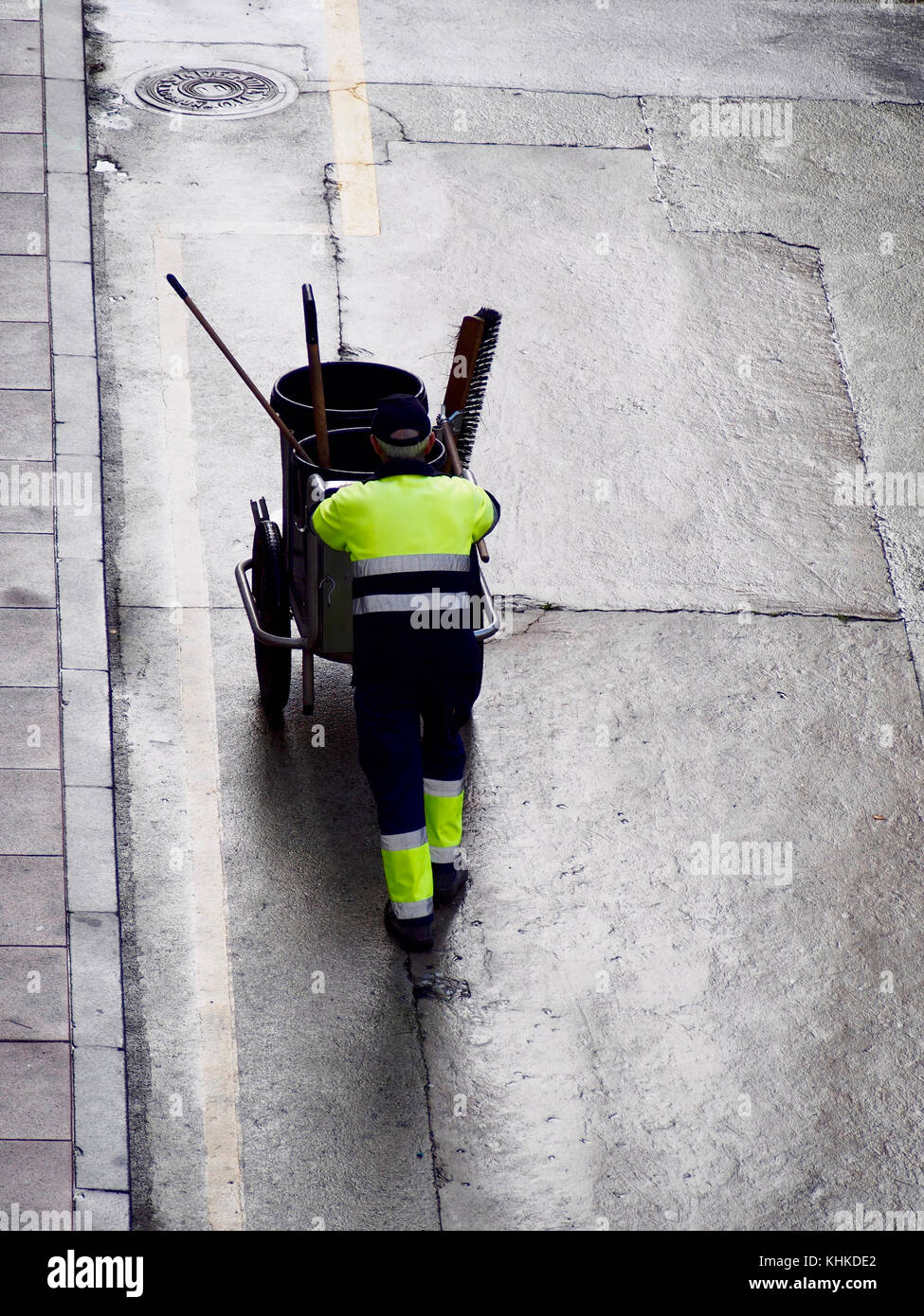 Unrecognizable sweeper taking trash trolley Stock Photo - Alamy