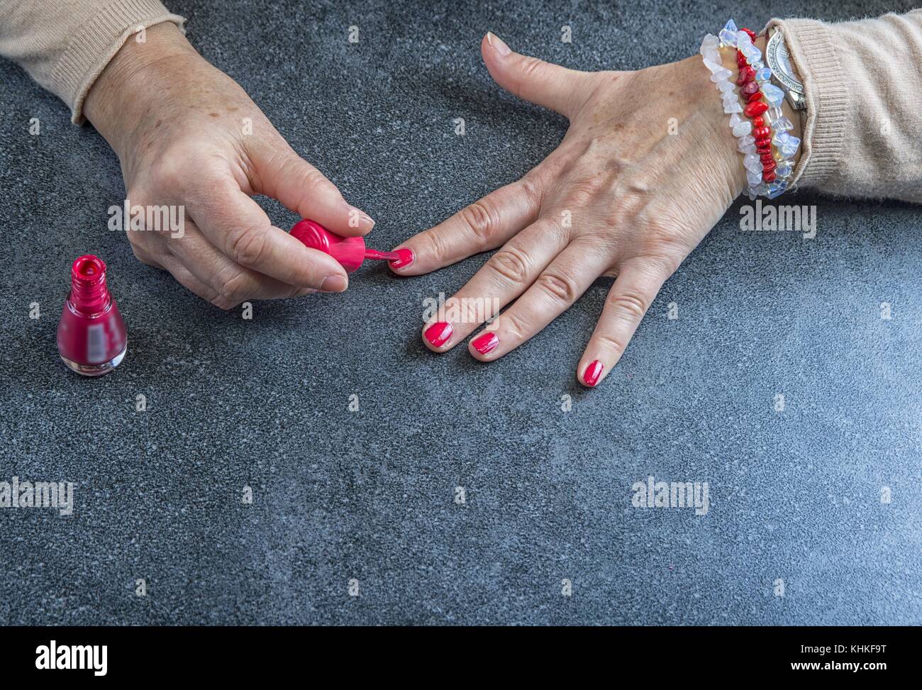 Manicure. Old Woman Hands Polishing Nails With Red Nail Polish In Beauty Salon Stock Photo - Alamy Manicure. Old Woman Hands Polishing Nails With Red Nail Polish In Beauty Salon Stock Photo - Alamy