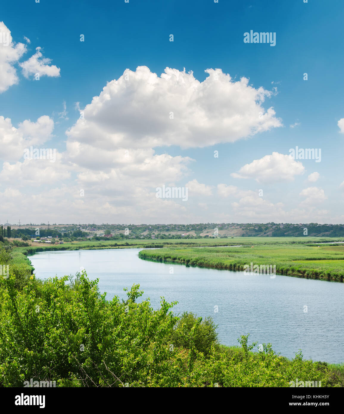 blue sky with white clouds over river in green riverside Stock Photo ...