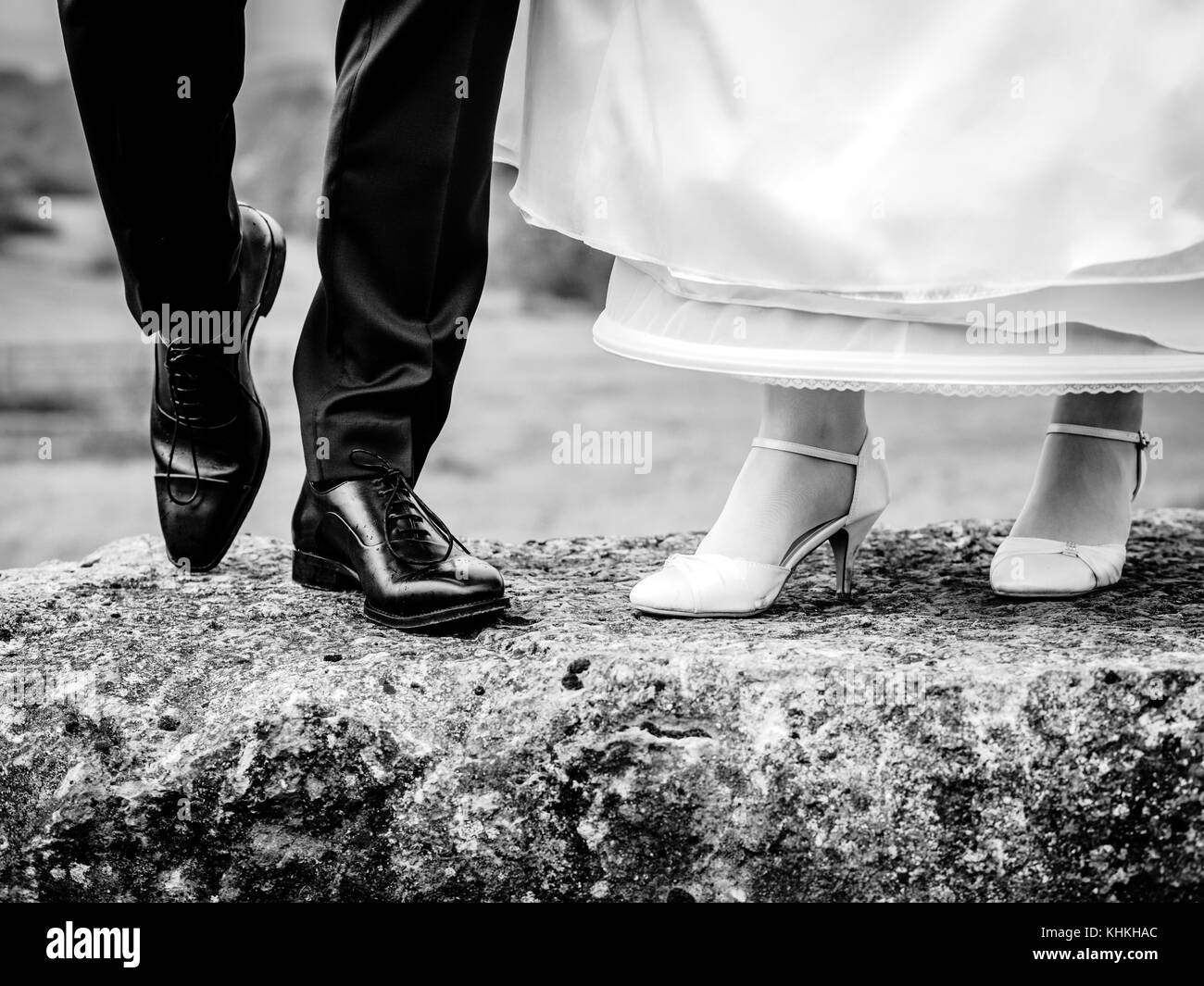 Bride and groom show their shoes Stock Photo