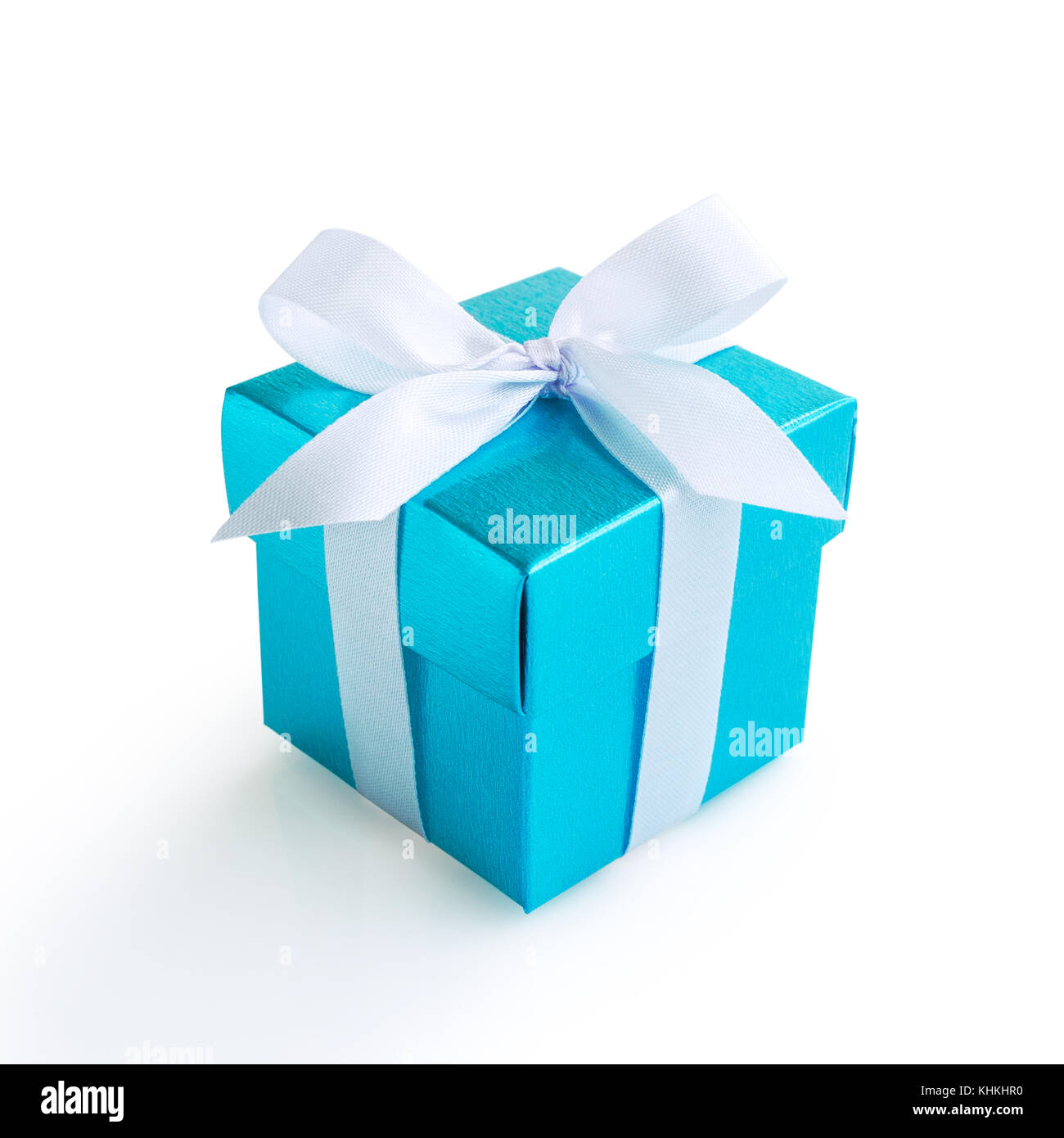 Blue gift box with white ribbon bow on white background Stock Photo - Alamy