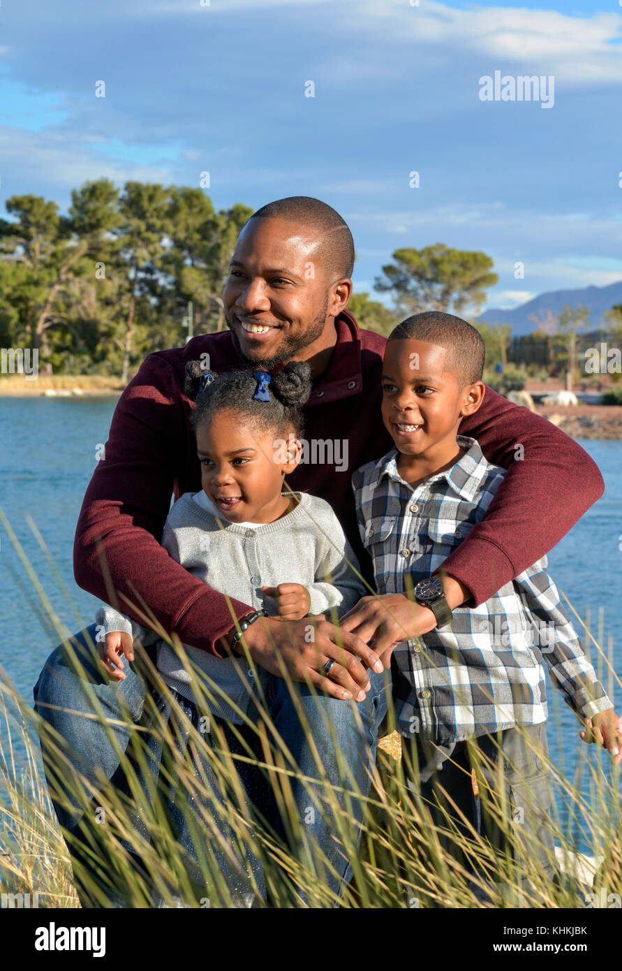 African American Man with son and daughter in a park. Stock Photo