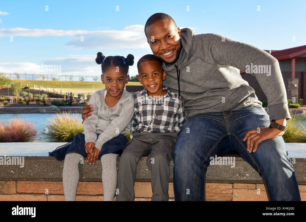 African American Man with son and daughter in a park, smiling, looking at camera Stock Photo
