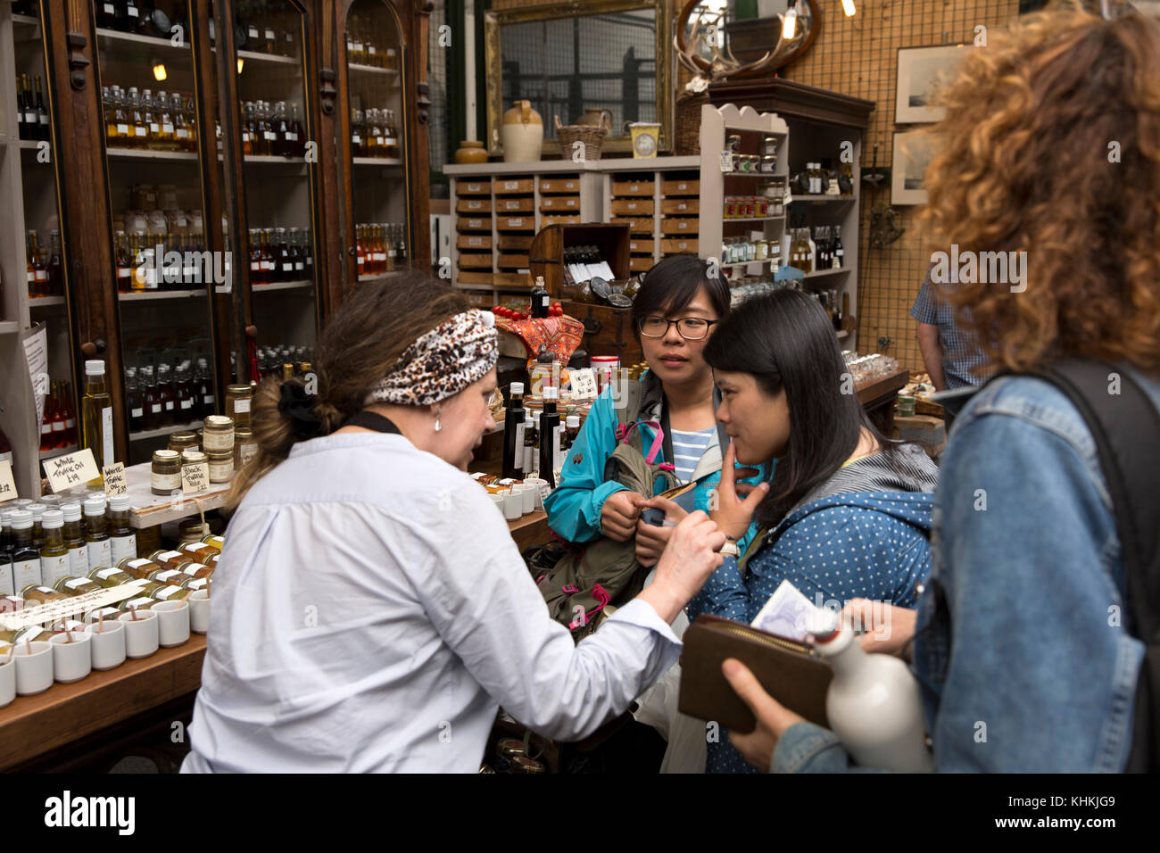 UK, London, Southwark, Borough Market, Three Crown Square, Japanese visitors at Fitz fine food stall Stock Photo