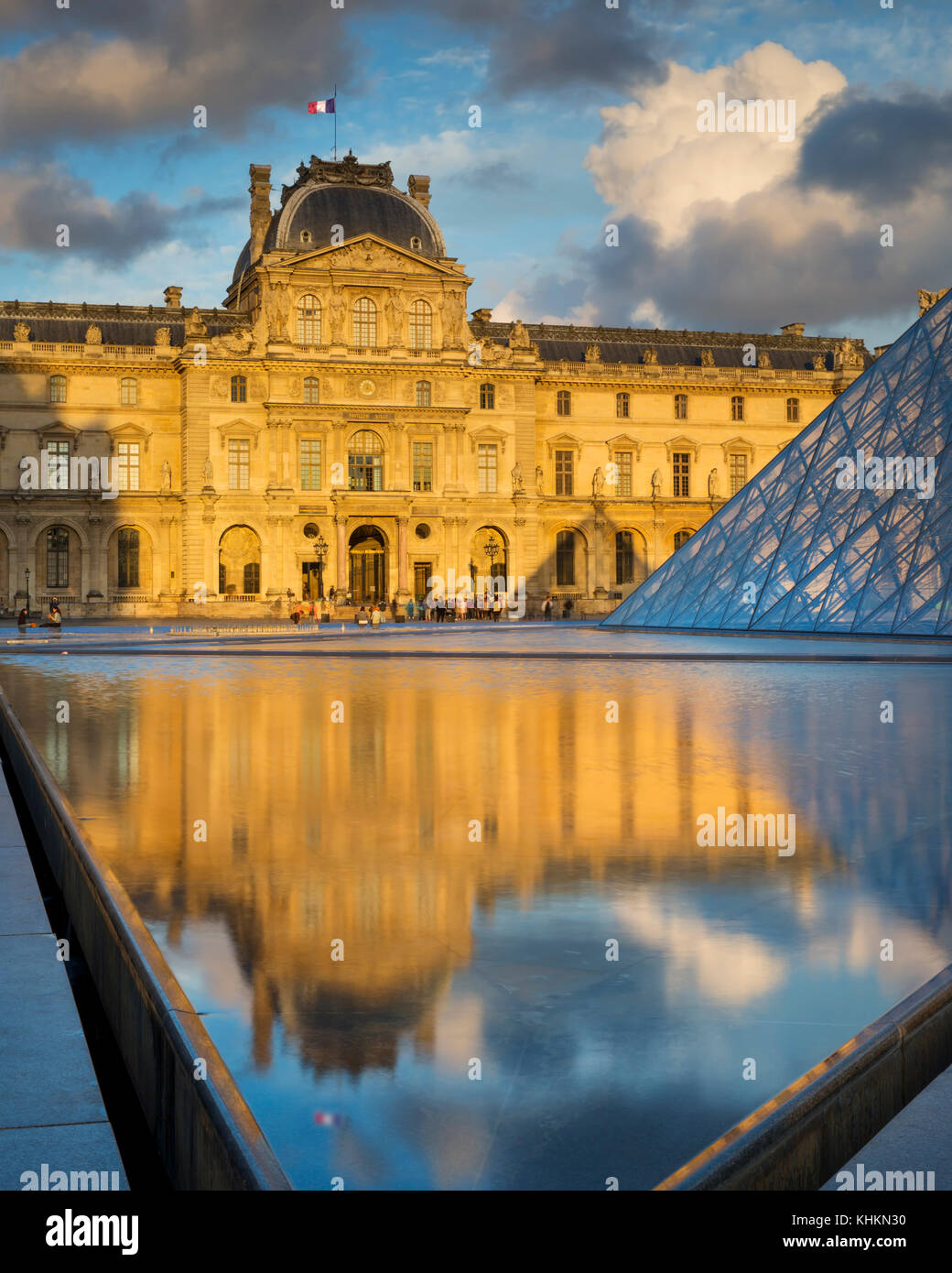 Colorful clouds at sunset over the courtyard of Musee du Louvre, Paris, France Stock Photo