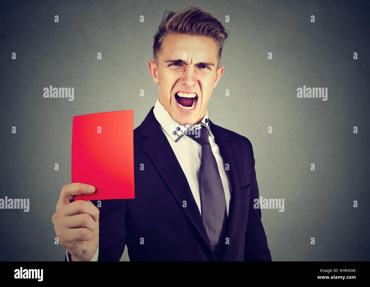Young frustrated man referee showing a red card Stock Photo