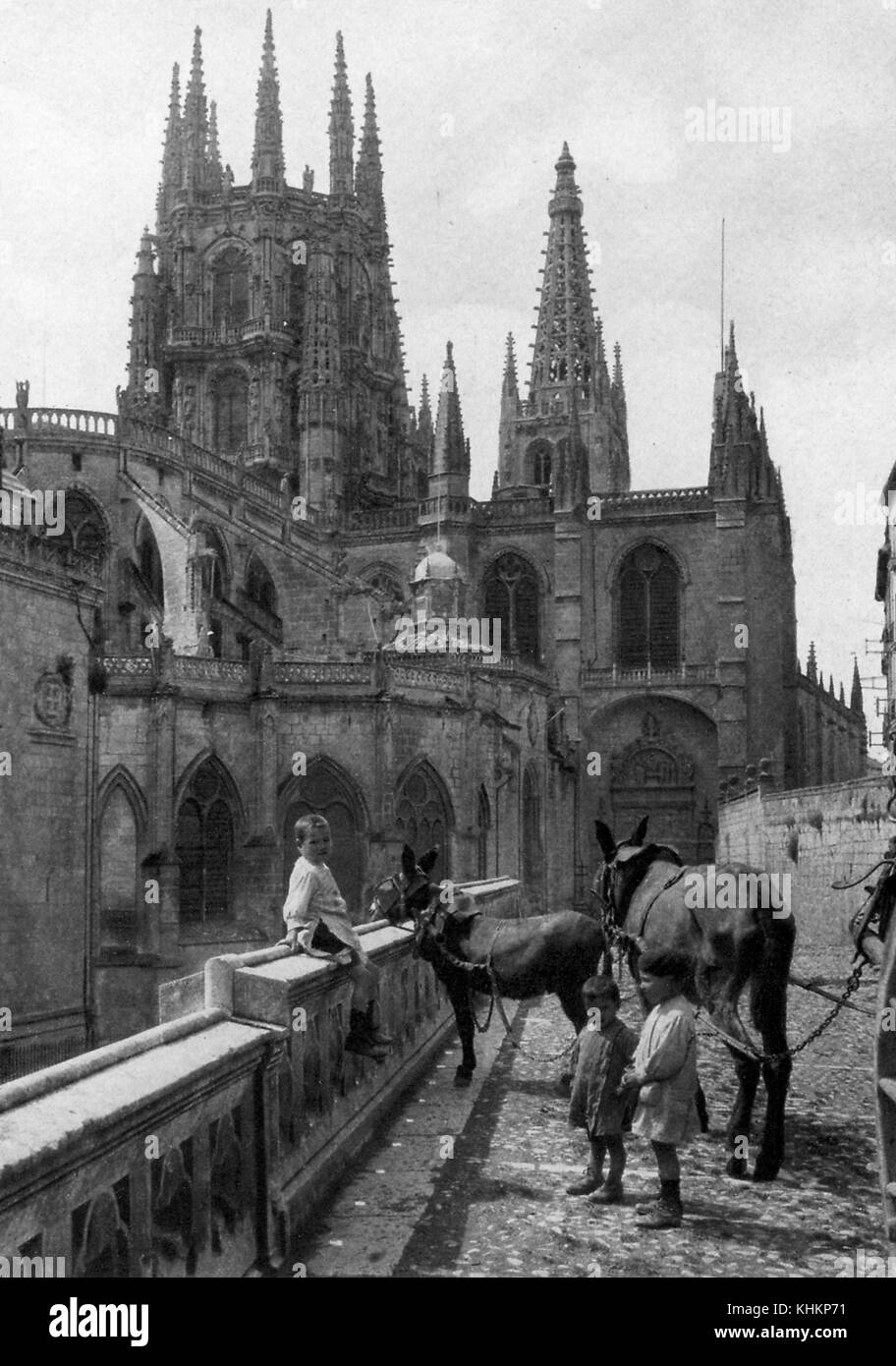 Burgos Cathedral, with small boys and donkeys standing in the foreground, Spain, 1922. Stock Photo