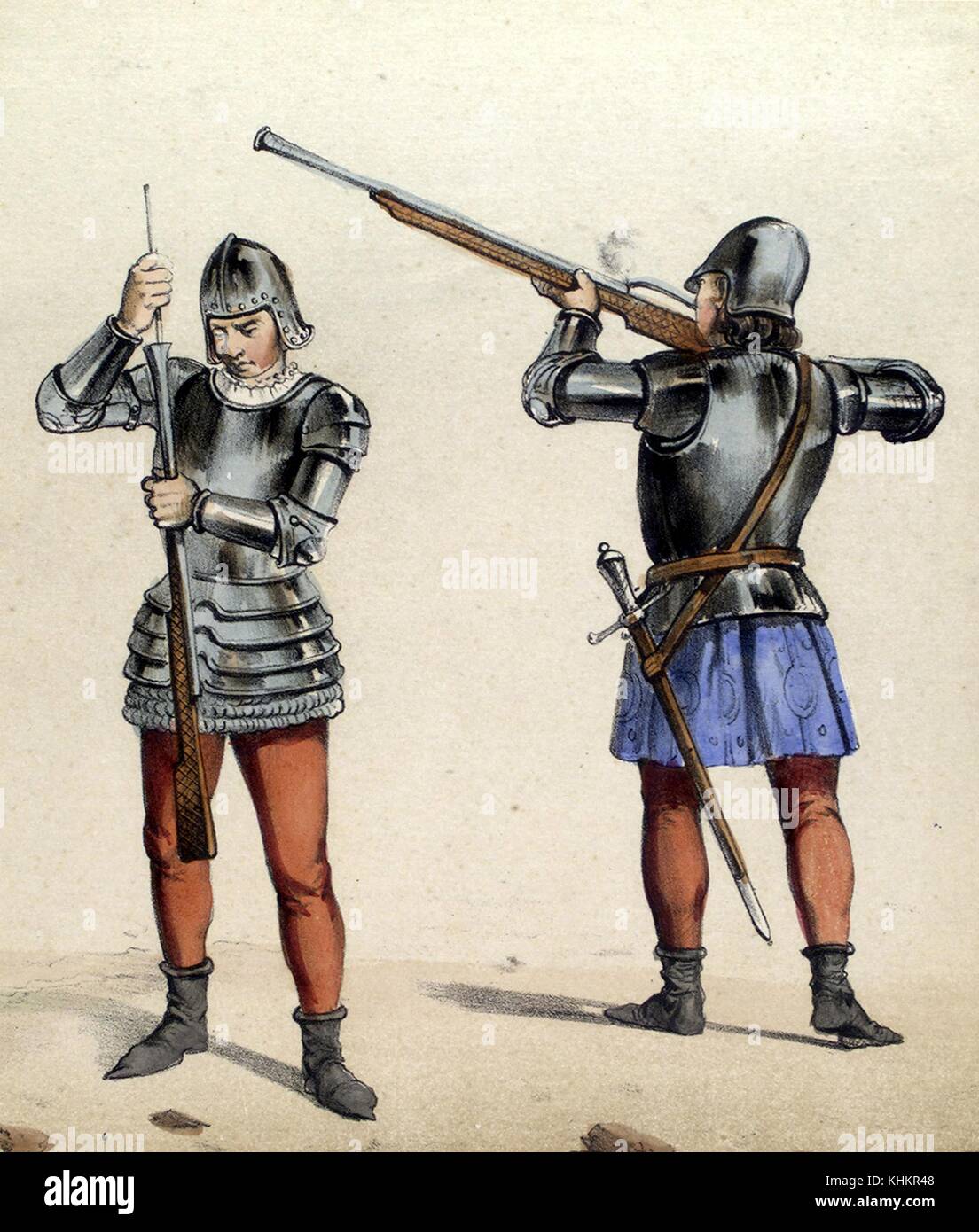 A color lithograph that depicts two different classes of Spanish soldiers as they would have appeared in 1493, the soldier on the left is reloading a rifle for the rifleman on the right who is firing his weapon, they both wear upper body armor and helmets along with red leggings, the soldier on the right also carries a sword and wears blue culottes, 1861. From the New York Public Library. Stock Photo