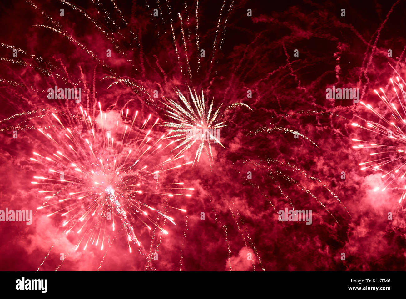 Explosions of red fireworks on the background on a dark night sky Stock Photo