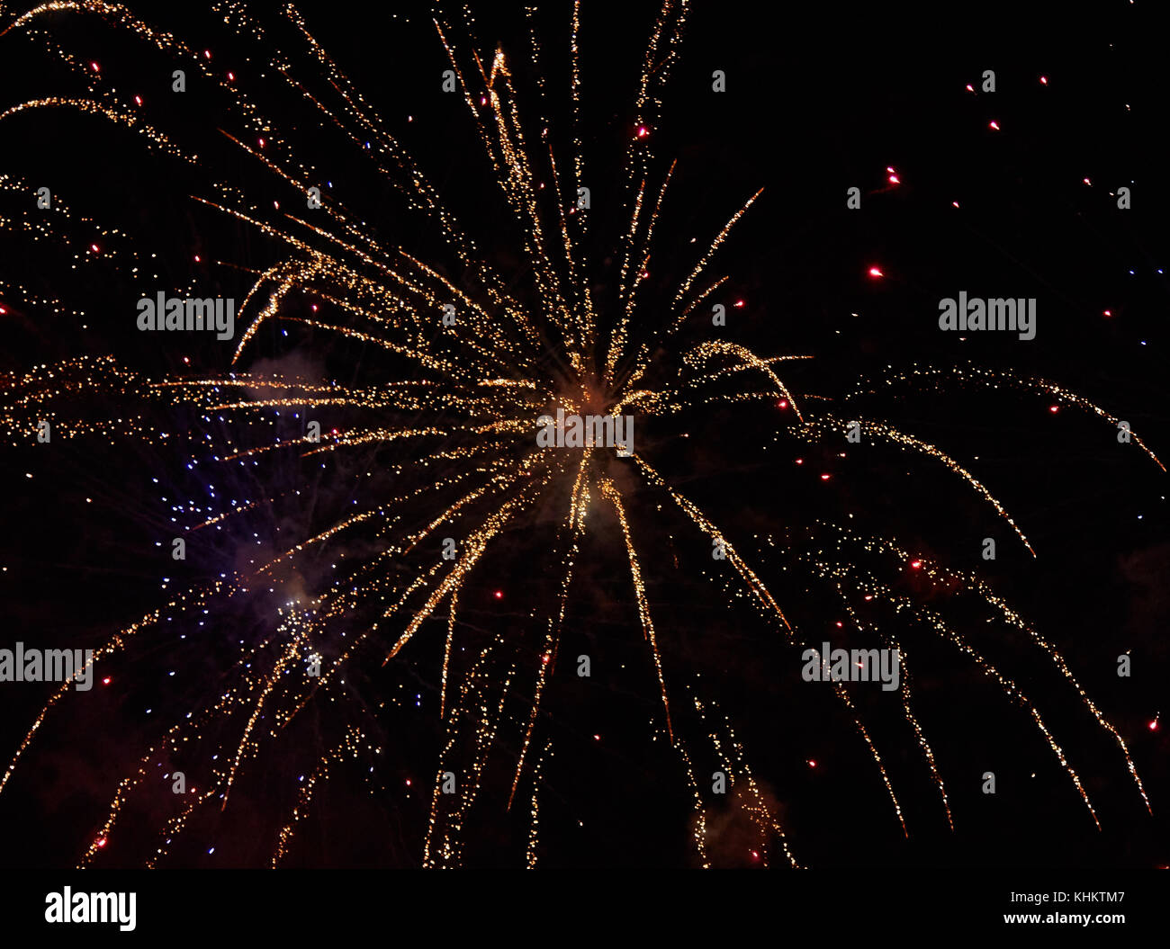 Explosion of yellow fireworks against the background of a dark night sky Stock Photo