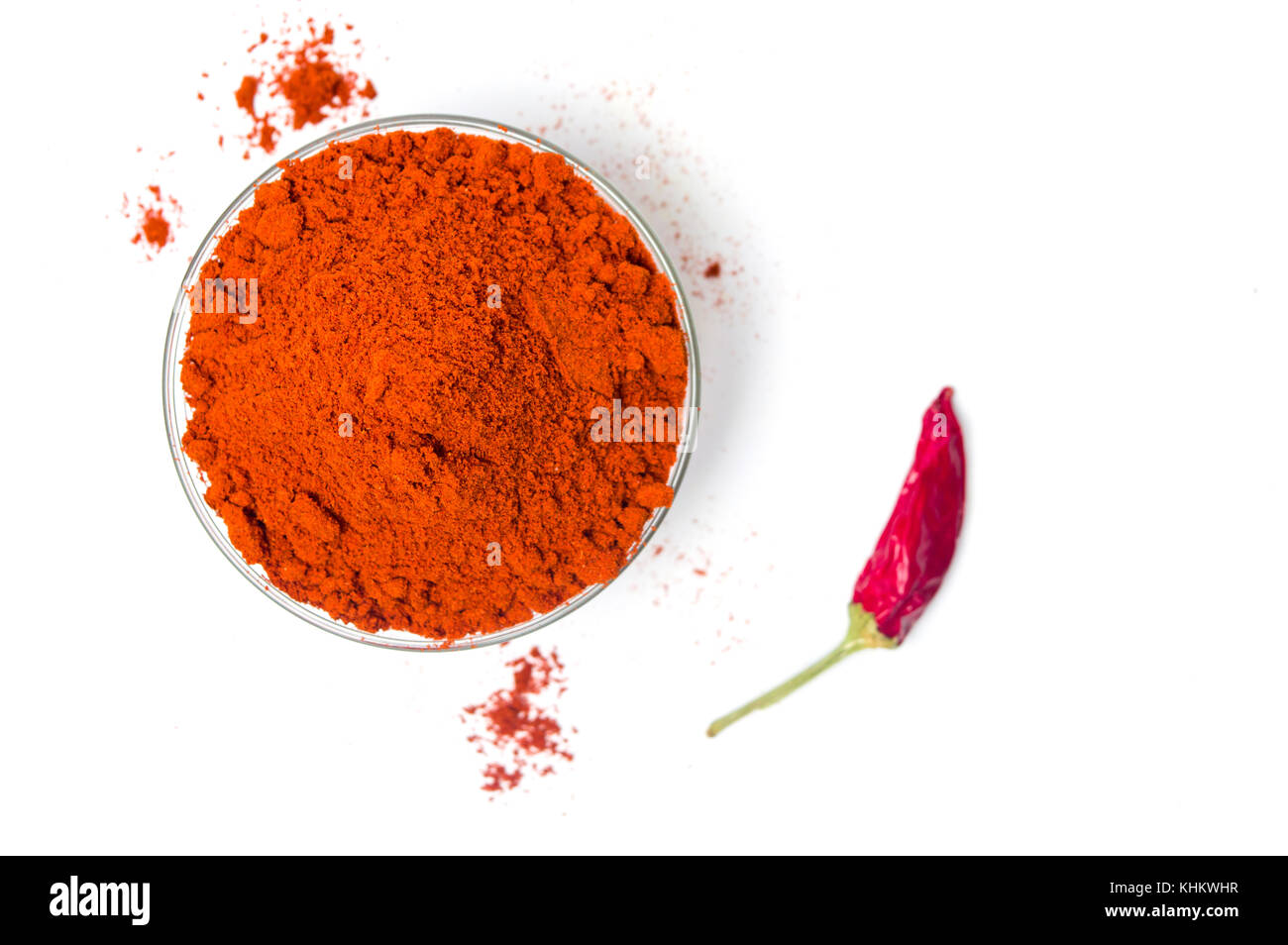 Ground red pepper in a glass bowl isolated Stock Photo
