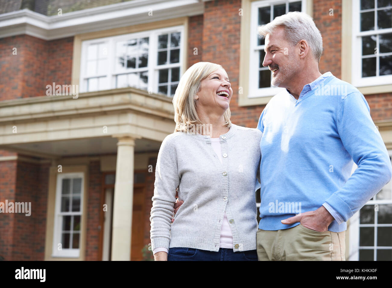 Smiling Mature Couple Standing Outside Home Stock Photo - Alamy