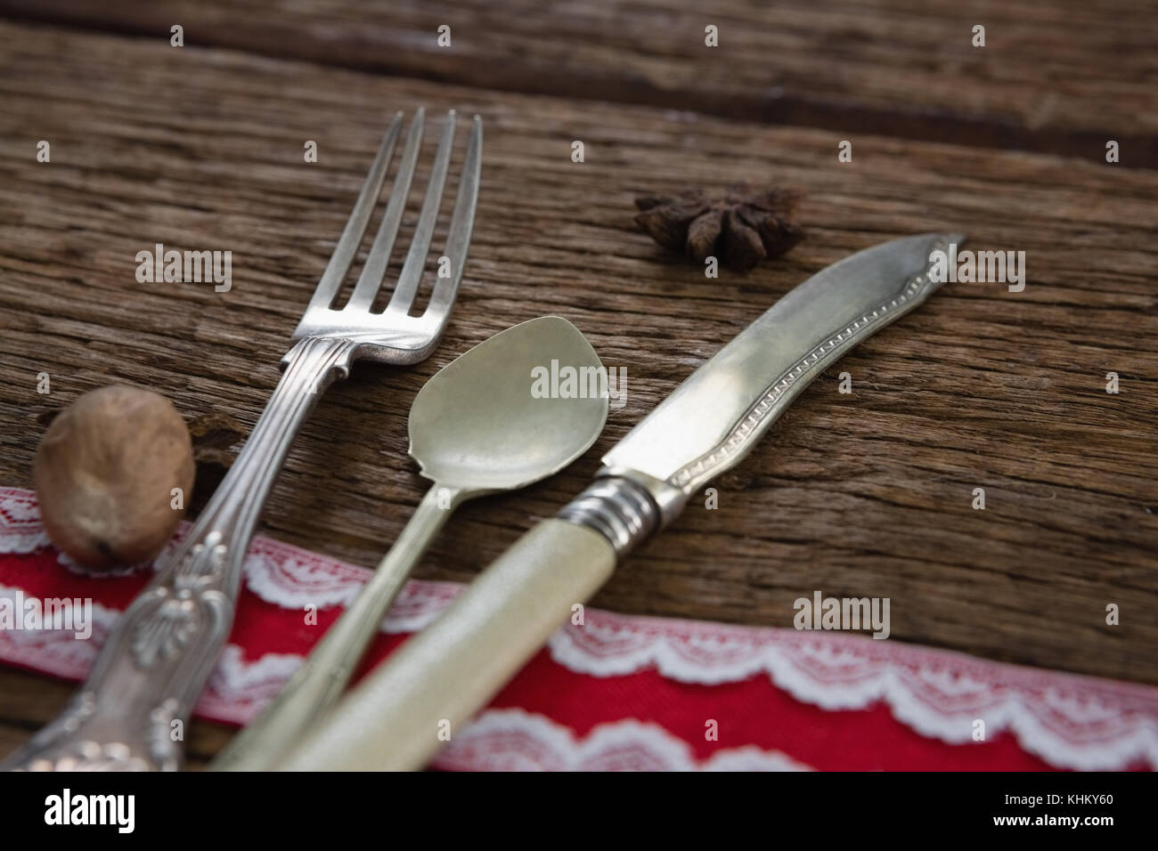 Cutlery with star anise and nutmeg on wooden table Stock Photo