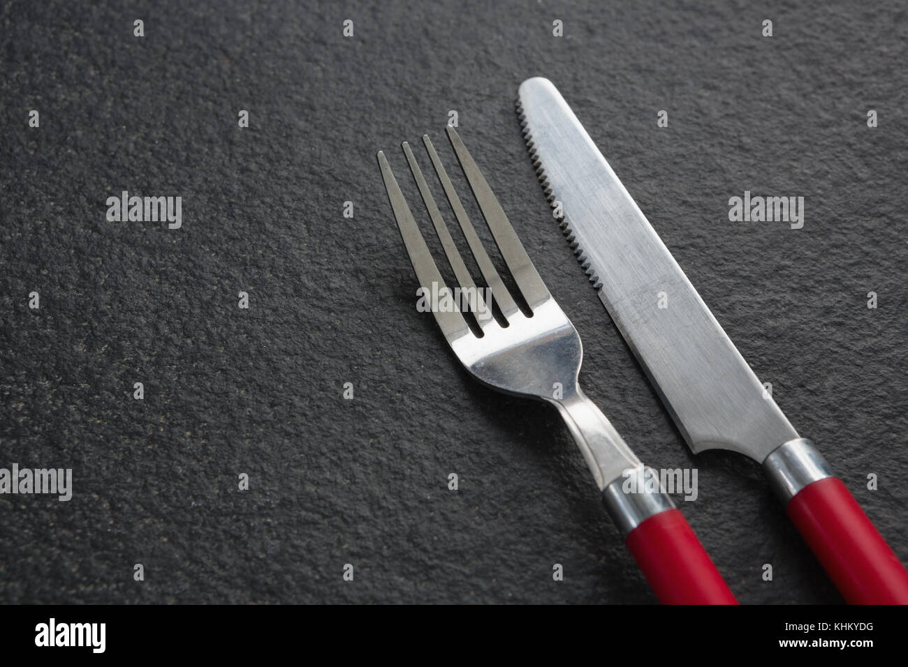 Closeup of fork and butter knife on black background Stock Photo Alamy