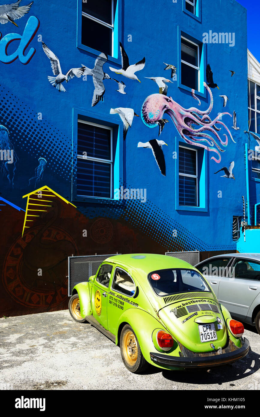 Green VW Beetle in front of painted house facade, Muizenberg, Cape Town, Western Cape, South Africa Stock Photo