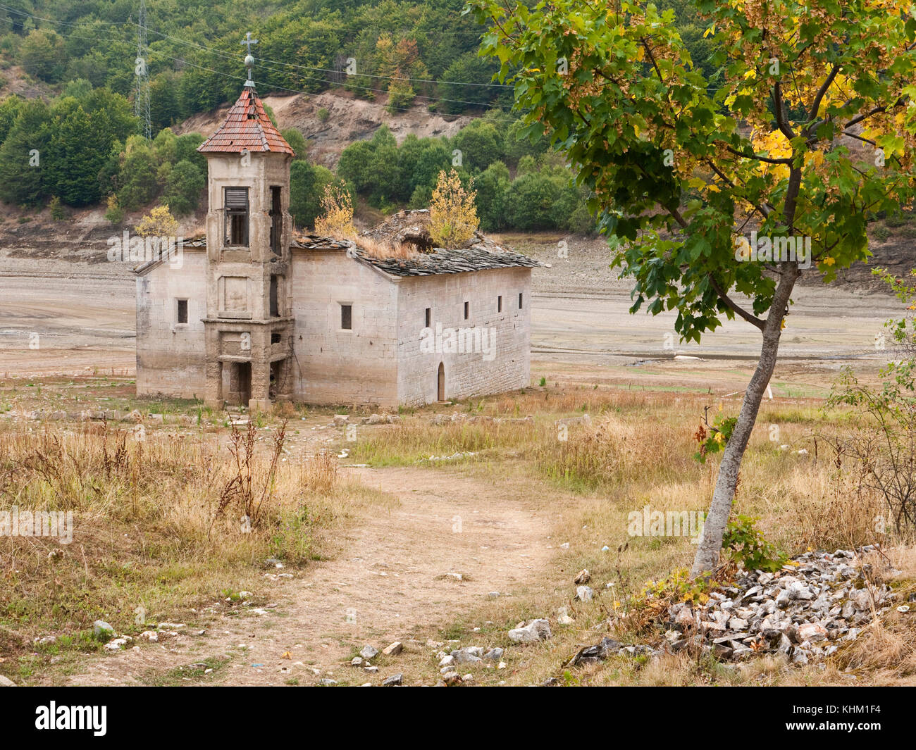 The old church of St Nicholas, usually partially submerged in Lake Mavrovo, Macedonia, fully emerges at times of low water level. Stock Photo