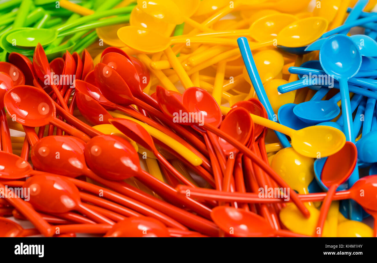 Background of many new colored plastic spoons Stock Photo - Alamy
