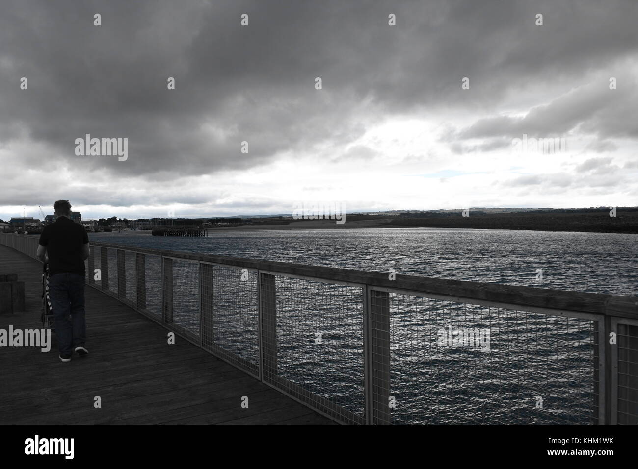 Pier walk and stormy skies Stock Photo