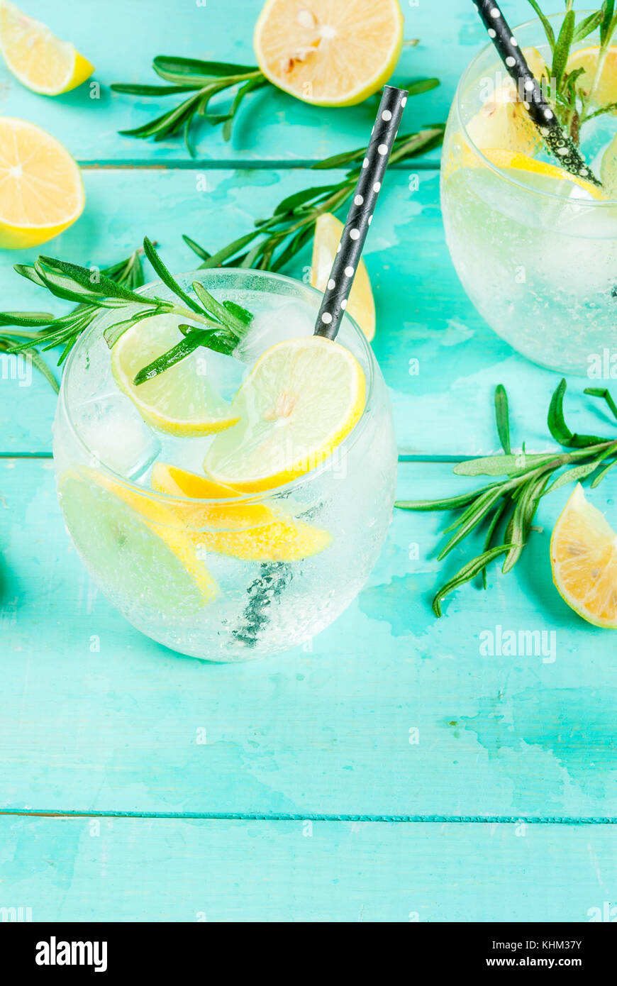 Cold lemonade or alcohol vodka cocktail with lemon and rosemary, on