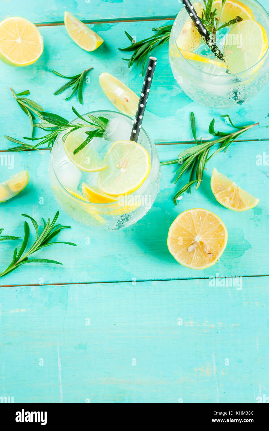 Cold lemonade or alcohol vodka cocktail with lemon and rosemary, on