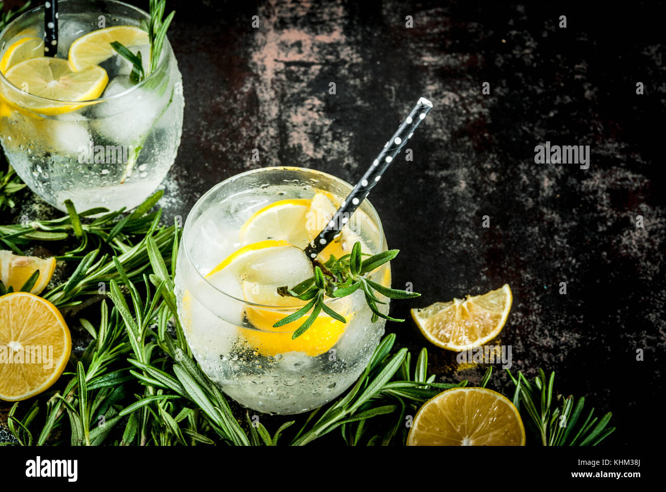 Cold lemonade or alcohol vodka cocktail with lemon and rosemary, On a