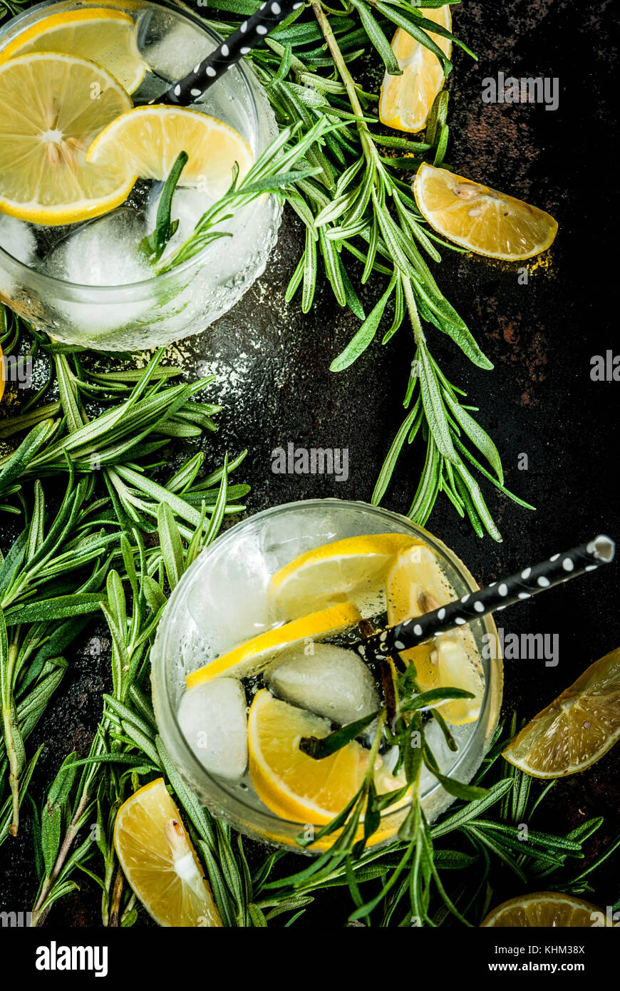 Cold lemonade or alcohol vodka cocktail with lemon and rosemary, On a